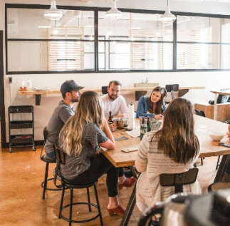 people-sat-at-table-talking