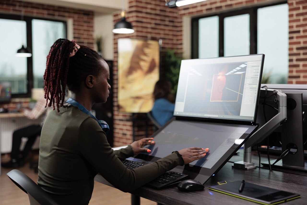 3d-digital-artist-sitting-at-computer-desk-while-w-2023-11-27-04-52-12-utc Large