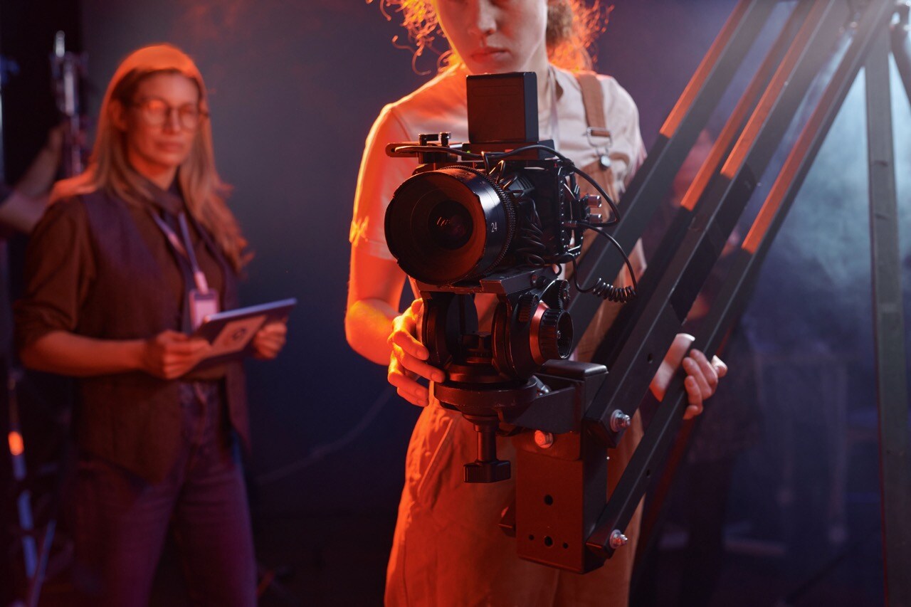 woman-operating-video-camera-in-neon-lights-2024-04-29-18-56-13-utc Large